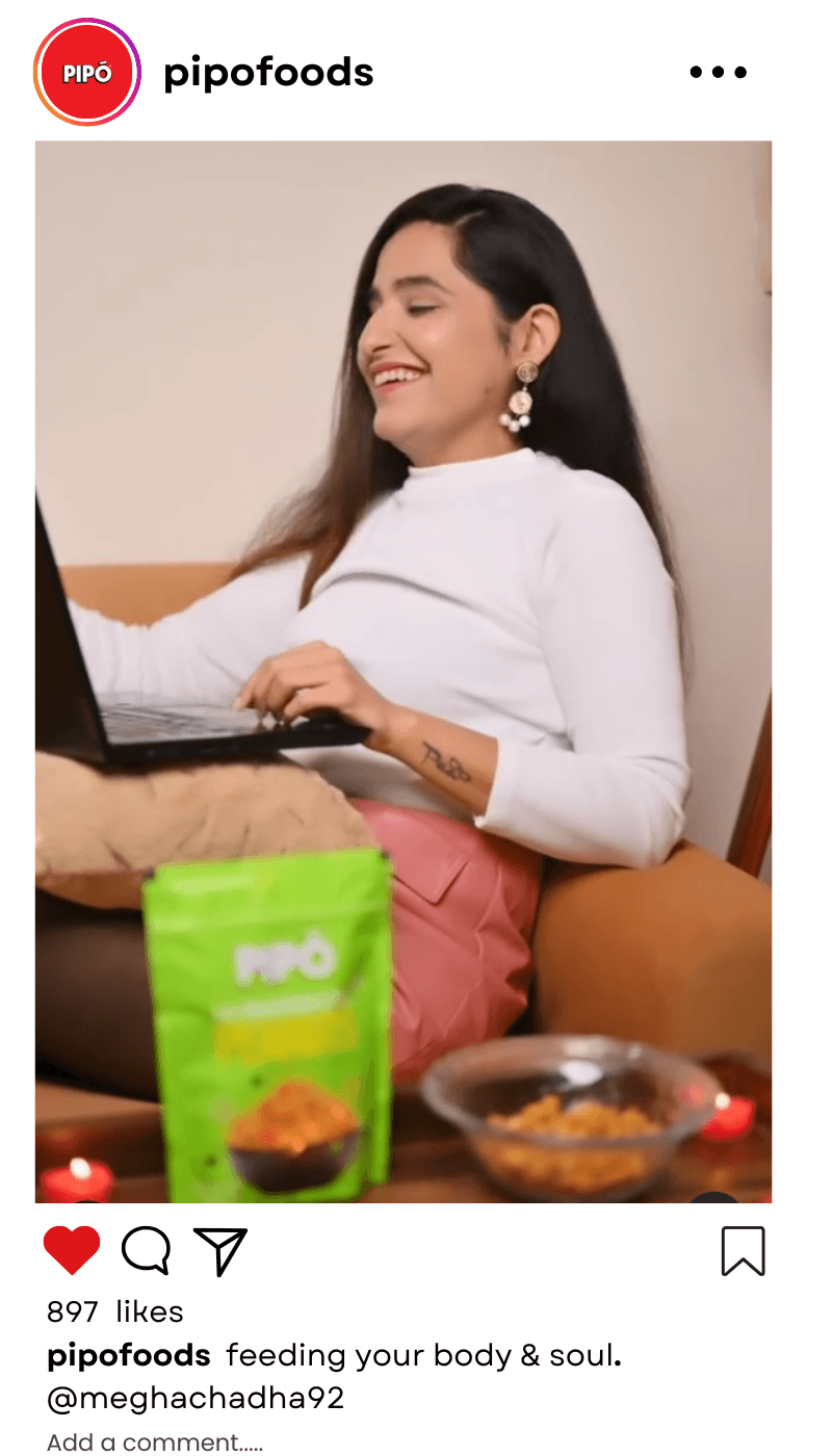 Mvisionary partners with influencers to boost Pipo Foods' brand, featuring a woman on her laptop enjoying Pipo peanuts.@meghachadha92