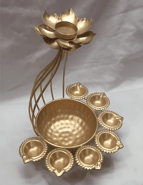 Golden decorative item with a lotus flower design, a central bowl, and seven smaller bowls arranged around it.